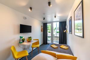 a bedroom with a bed and a table and chairs at Apartments24 CITYBOX in Rakvere