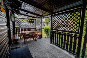 a screened porch with a bench and a fence at Holiday Home Brina 69 in Čatež ob Savi