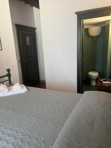 a bedroom with a bed with two towels on it at A La Casa Dei Potenti in San Gimignano