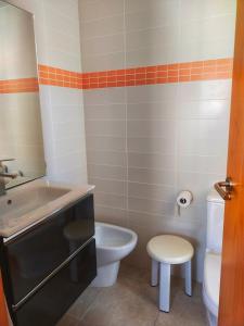 a small bathroom with a toilet and a sink at Chula Vista Apartamento, 200m de la playa, piscina, parking in Daimuz +20 photos