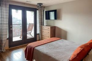 a bedroom with a bed and a door with a balcony at Mountain Views at Dolly's Castle Unit 7 in Sevierville