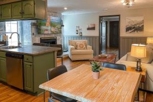 a kitchen and living room with a wooden table and a kitchen and a living room at Mountain Views at Dolly's Castle Unit 7 in Sevierville +13 photos