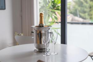 a bottle of champagne in a bucket on a table at Sunflower Luxury Loft w AC Downtown and Metro in Porto