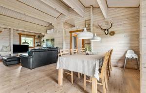 a dining room with a table and a couch at Beautiful Home In Hemmet With Kitchen in Hemmet