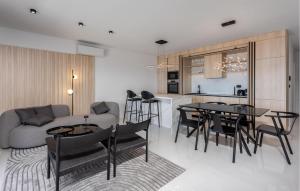 a living room with a couch and a table and chairs at Gorgeous Apartment In Novi Vinodolski in Novi Vinodolski