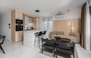 a kitchen and living room with a table and chairs at Beautiful Apartment In Novi Vinodolski in Novi Vinodolski