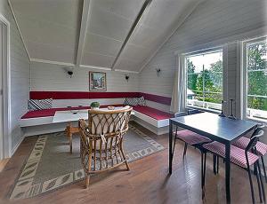 a living room with a bench and a table at Selje Camping - Hytte Nr 5 in Selje