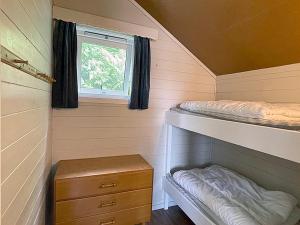 a small bedroom with a bunk bed and a window at Selje Camping - Hytte Nr 5 in Selje