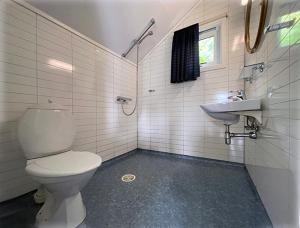 a bathroom with a toilet and a sink at Selje Camping - Hytte Nr 5 in Selje