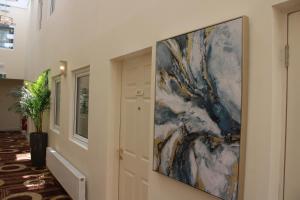 a large painting hanging on a wall in a hallway at Kildare House Hotel in Kildare