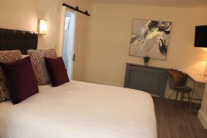 a bedroom with a large white bed in a room at Kildare House Hotel in Kildare