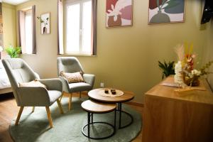 a living room with two chairs and a table at SPA rêve nature in Calais +3 photos