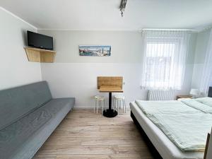 a bedroom with a bed and a desk at Chatka Morska in Karwia