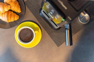 a cup of coffee and a plate of croissants at Vila Aris in Kostrena