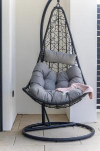 a black swing chair with pillows in a room at Vila Aris in Kostrena