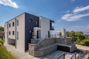 a house with a staircase in front of it at Vila Aris in Kostrena