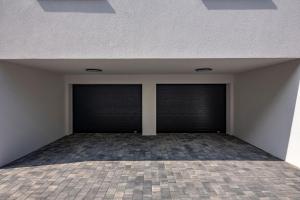 an empty room with two garage doors in a building at Vila Aris in Kostrena +26 photos