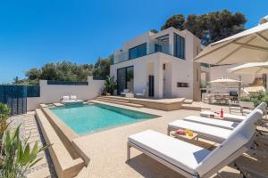 a villa with a swimming pool and a house at Ventus Villa - A Luxury Sea View Retreat in Akrotiri in Akrotiri