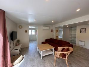 塞里尼昂"LE MARINA" Maison & Appartements proche de la mer avec piscine的带沙发和桌子的客厅