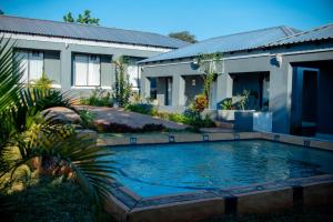 a swimming pool in front of a house at Lugogo Guesthouse in Thohoyandou