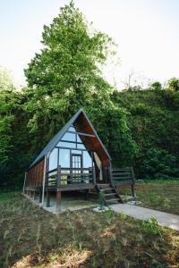a small cabin with a bench in a park at Mora Farmhouse in Ardeşen +23 photos