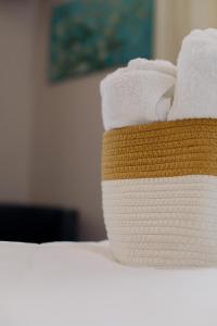 a stack of towels sitting on top of a bed at Garden Bungalow in Kórinthos