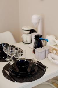 a table with plates and wine glasses on a counter at Garden Bungalow in Kórinthos