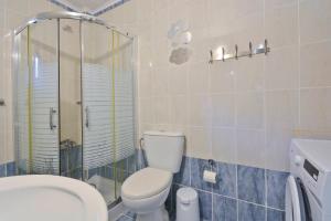 a bathroom with a toilet and a glass shower at Calm & Peaceful in Gouvia +28 photos