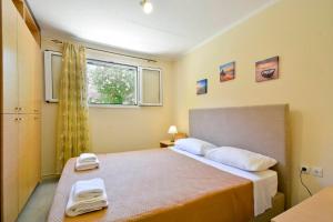 a bedroom with a bed with two towels on it at Calm & Peaceful in Gouvia