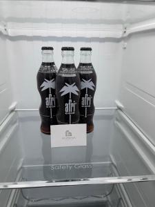 two bottles of soda sitting in a refrigerator at Deluxe Apartment Bochum 1 BEDROOM in Bochum +14 photos