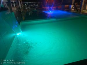 a swimming pool with blue lights in the water at Tein room in Rengit