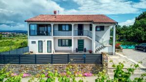 a white house with a red roof at NAT Apartments in Koper