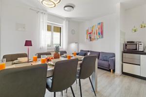 a dining room and living room with a table and chairs at NAT Apartments in Koper