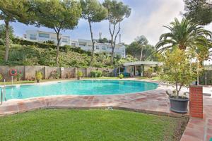 a swimming pool in the middle of a yard at Jardín Miraflores in Mijas Costa
