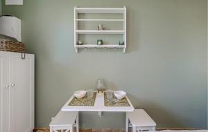 Una mesa blanca en una habitación con estantes blancos. en Nice Apartment In Saint-Palais-Sur-Mer, en Saint-Palais-sur-Mer
