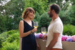 a man and a woman holding glasses of wine at Agrirelais La Bolla in Agliè