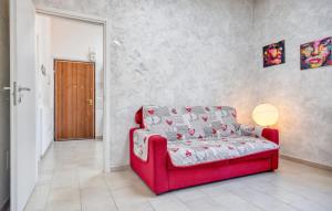 a red couch in a living room with a lamp at Awesome Apartment In Casarza Ligure in Casarza Ligure +7 photos