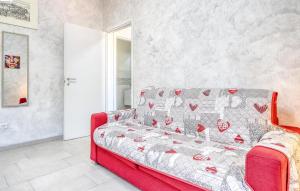 a living room with a red couch with hearts on it at Awesome Apartment In Casarza Ligure in Casarza Ligure