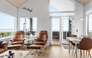 a living room with leather chairs and a table at Two-Bedroom Holiday Home In Bjert in Binderup Strand