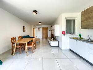 a kitchen and dining room with a table and chairs at Msida Central Suites - EMMNIC Court in Msida