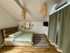 a bedroom with a bed with a green blanket at EPIC Vila Brașov, Cristian in Braşov