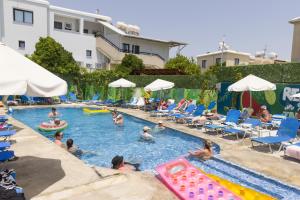 a group of people in a swimming pool at Alecos Hotel Apartments in Paphos