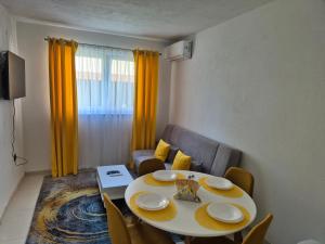 a room with a table and chairs and a dining room at Mahala Apartments in Visoko