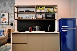 a kitchen with a counter and a refrigerator at Lujza B studio 44 in Budapest
