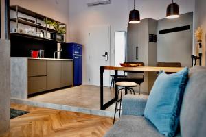 a kitchen and living room with a table and a couch at Lujza B studio 44 in Budapest