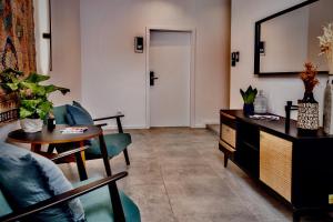 a living room with a table and chairs and a door at Lujza B studio 44 in Budapest +2 photos