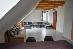 a living room with a couch and a table at Penzion U Emy in Třeboň