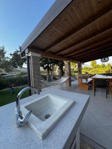 a kitchen sink on a counter next to a patio at Kuća za odmor Nera in Komin