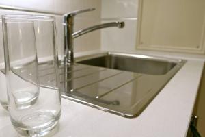 a kitchen sink with a glass vase next to it at 37chats studio in London
