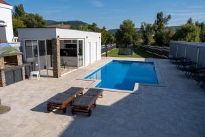 a patio with a swimming pool and a building at Villa Verona in Mostar